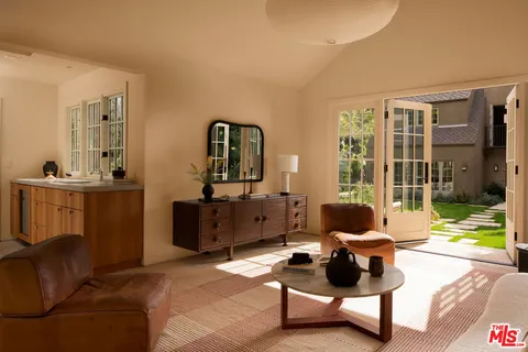 a view of a patio with a table and chairs and potted plants