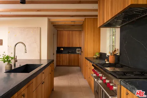 a kitchen with granite countertop a stove and a sink
