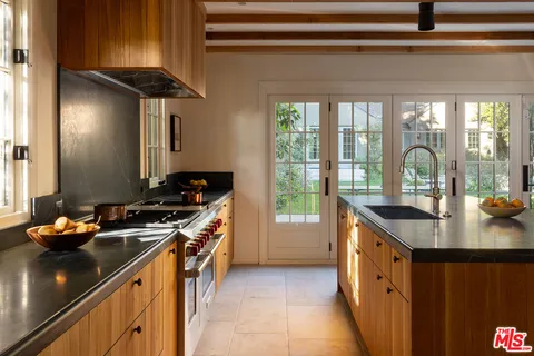 a kitchen with stainless steel appliances a sink stove and cabinets