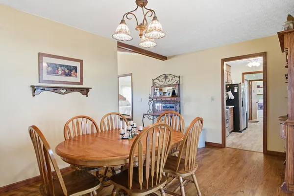 a view of a dining room with furniture wooden floor and a chandelier