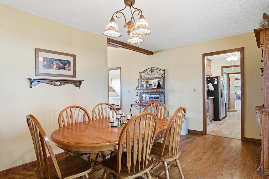 6389 Ruebush Road Dublin, VA 24084 - Photo 13 of 63 a view of a dining room with furniture wooden floor and a chandelier
