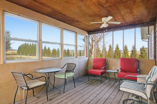 a living room with furniture and a floor to ceiling window