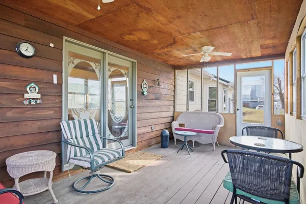 a balcony with furniture and wooden floor