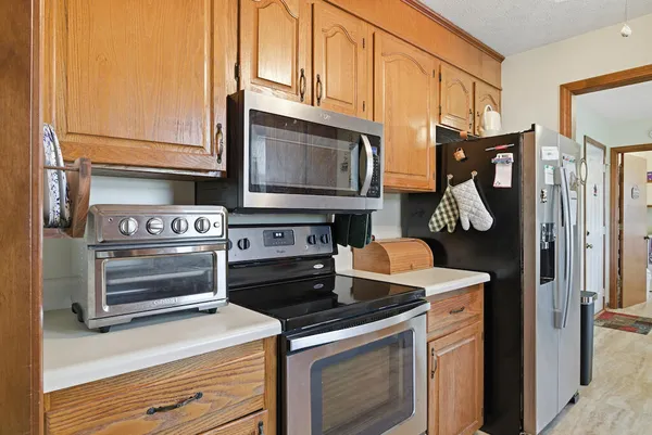 a kitchen with stainless steel appliances a stove a microwave and cabinets