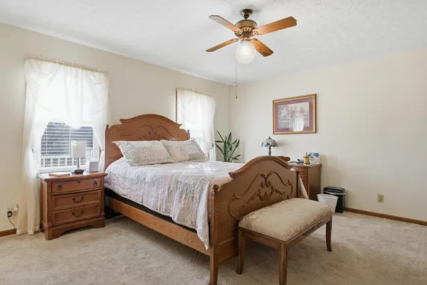 a spacious bedroom with a bed and a table