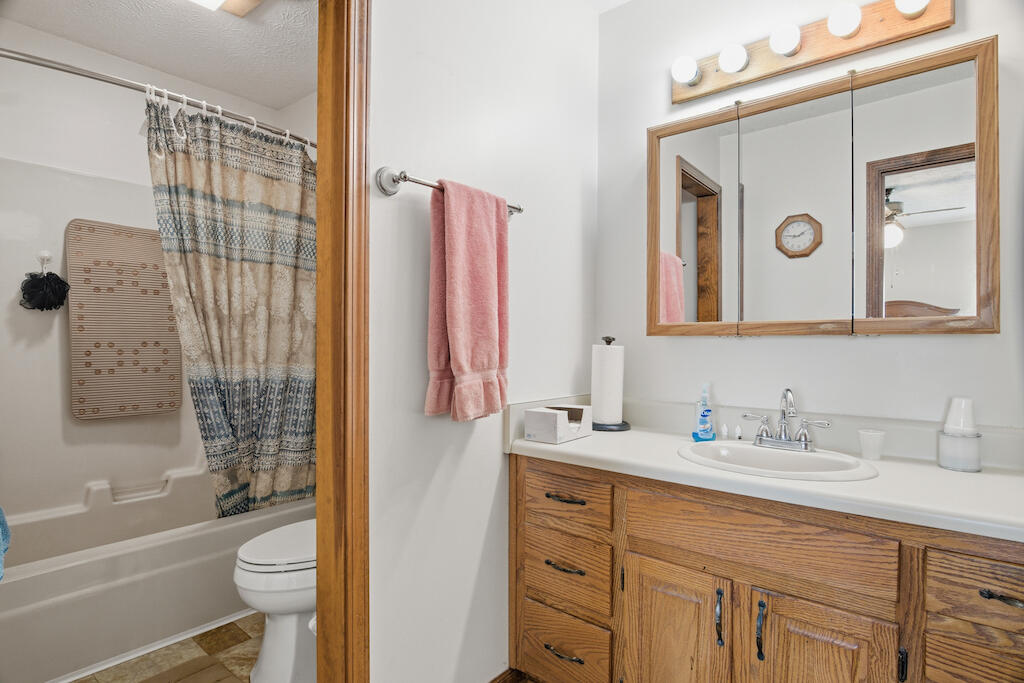 6389 Ruebush Road Dublin, VA 24084 - Photo 26 of 63 a bathroom with a granite countertop sink toilet and shower