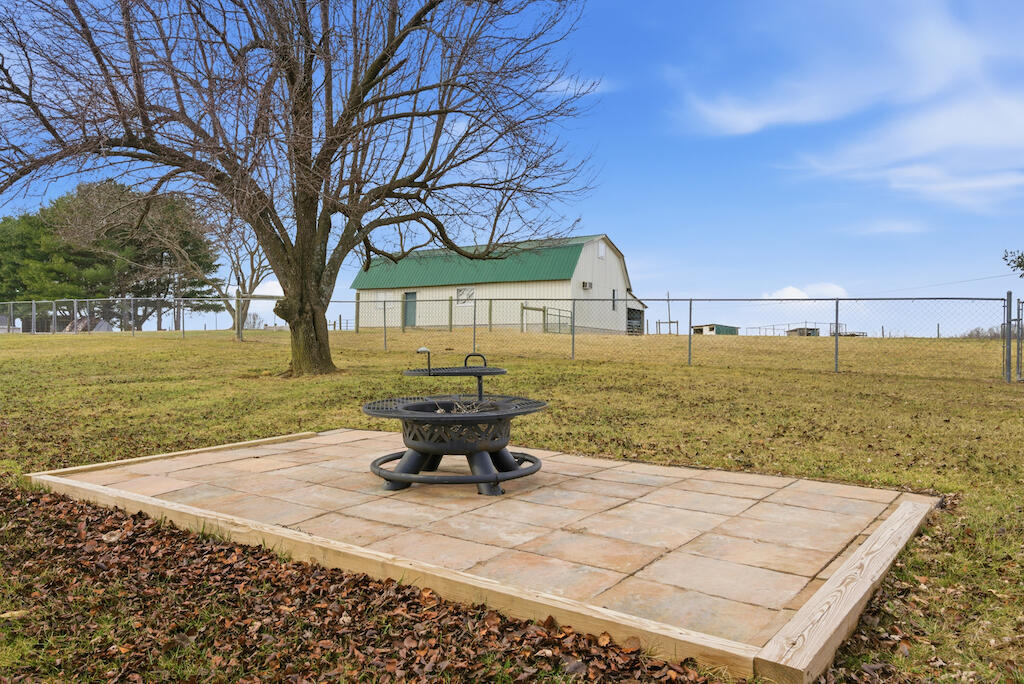6389 Ruebush Road Dublin, VA 24084 - Photo 63 of 63 a view of a backyard with lawn chairs under an umbrella