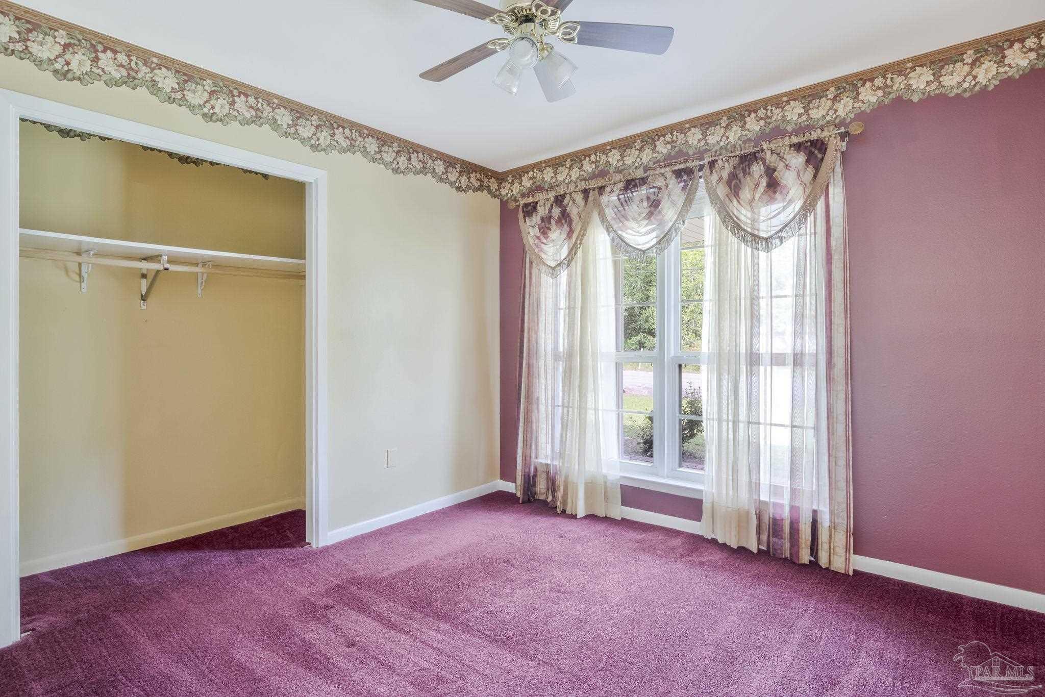 4411 Pace Lane Pace, FL 32571 - Photo 33 of 68 a view of a room with a window and a ceiling fan
