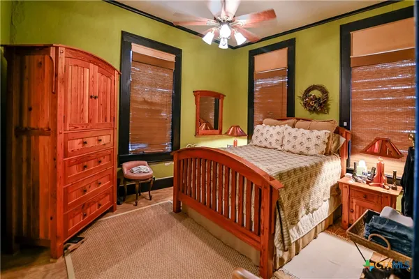 a bedroom with furniture and a window