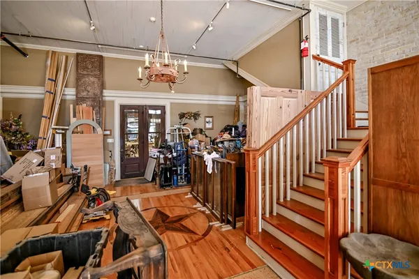 a view of a room with lots of wooden furniture