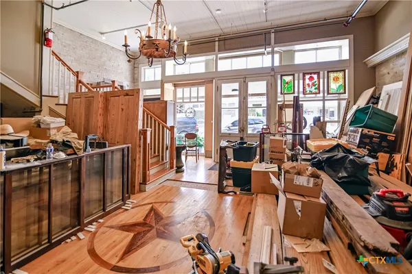 a view of a livingroom with furniture a floor to ceiling window and a ceiling fan