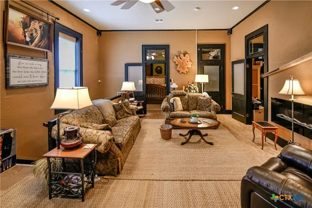 a living room with furniture a rug and a table