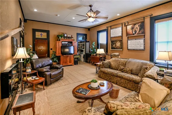 a living room with furniture a rug and a large window