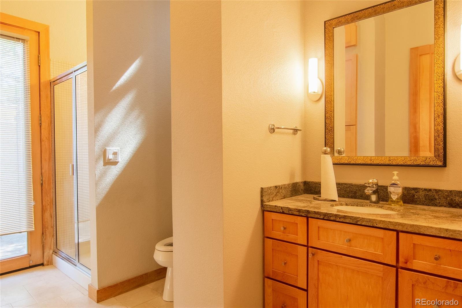 2895 Lafayette Drive Boulder, CO 80305 - Photo 7 of 12 a bathroom with a granite countertop sink and a mirror