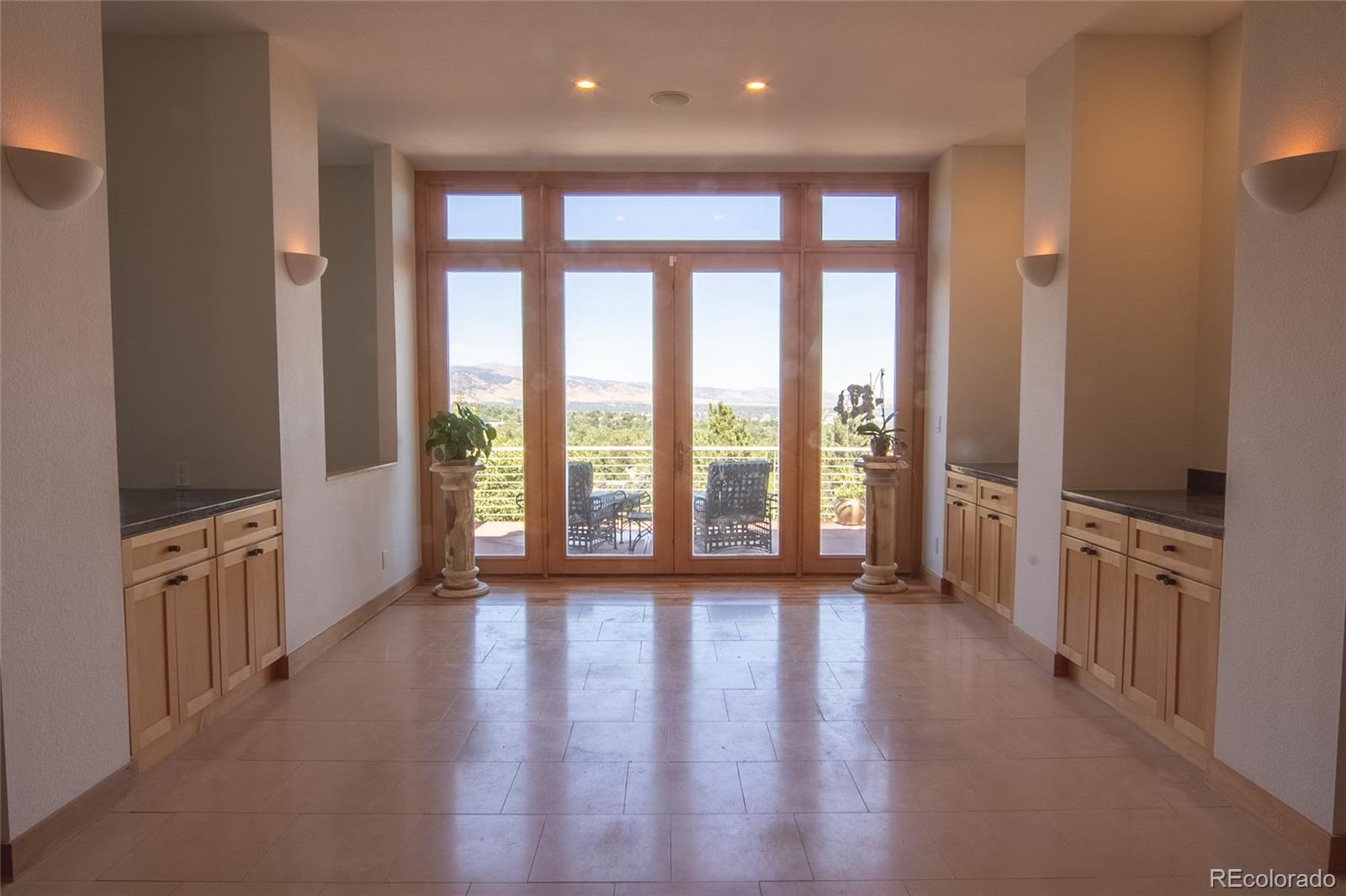 2895 Lafayette Drive Boulder, CO 80305 - Photo 8 of 12 a view of an empty room with a large window and wooden floor