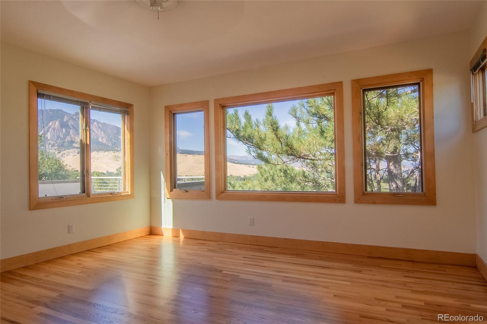 2895 Lafayette Drive Boulder, CO 80305 - Photo 9 of 12 a view of an empty room with wooden floor and a window