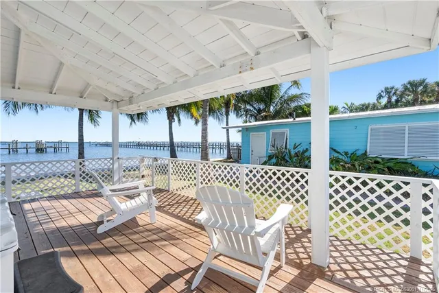 a view of a dinning table and chairs in patio of the house