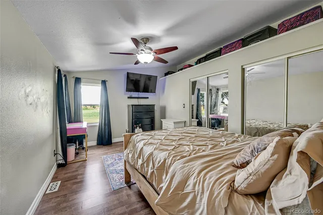 a dining room with furniture a chandelier and wooden floor