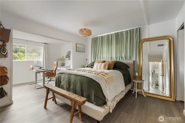 a view of a hallway with wooden floor and a couch