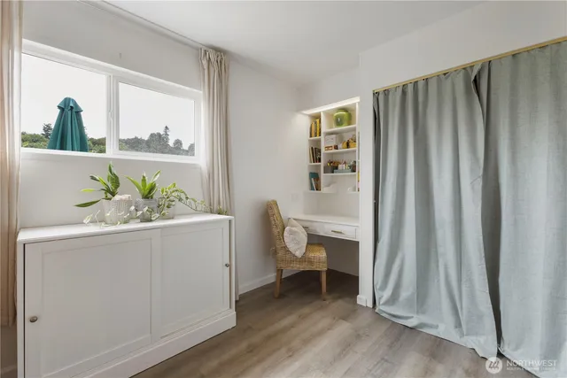 a bedroom with a large bed and a window