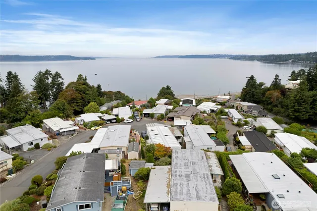 a view of a house with pool and chairs