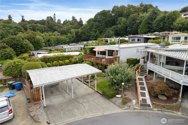 a view of a patio with table and chairs under an umbrella