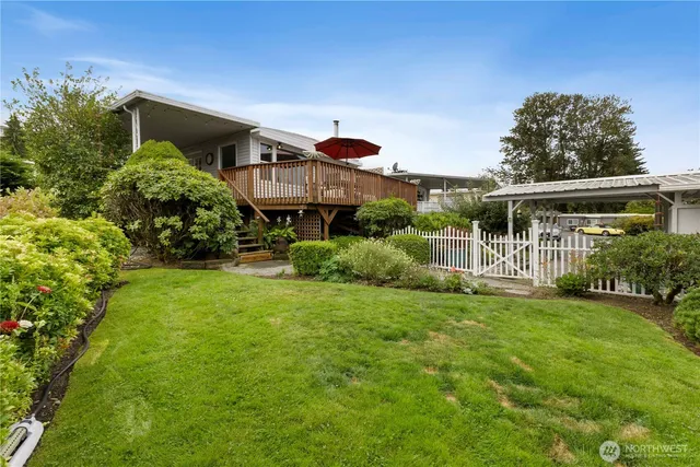 a view of a house with backyard sitting area and garden