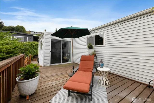a living room with furniture floor to ceiling window and a flat screen tv