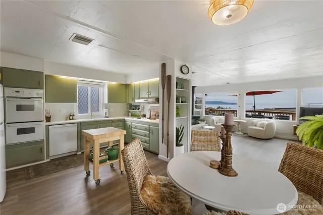 a view of a kitchen with furniture and wooden floor
