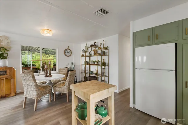 a view of a dining room with furniture and a potted plant
