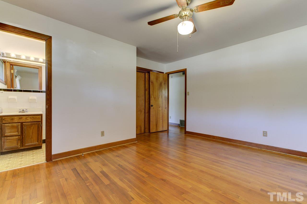3912 Buffaloe Road Raleigh, NC 27604 - Photo 5 of 8 an empty room with wooden floor and windows