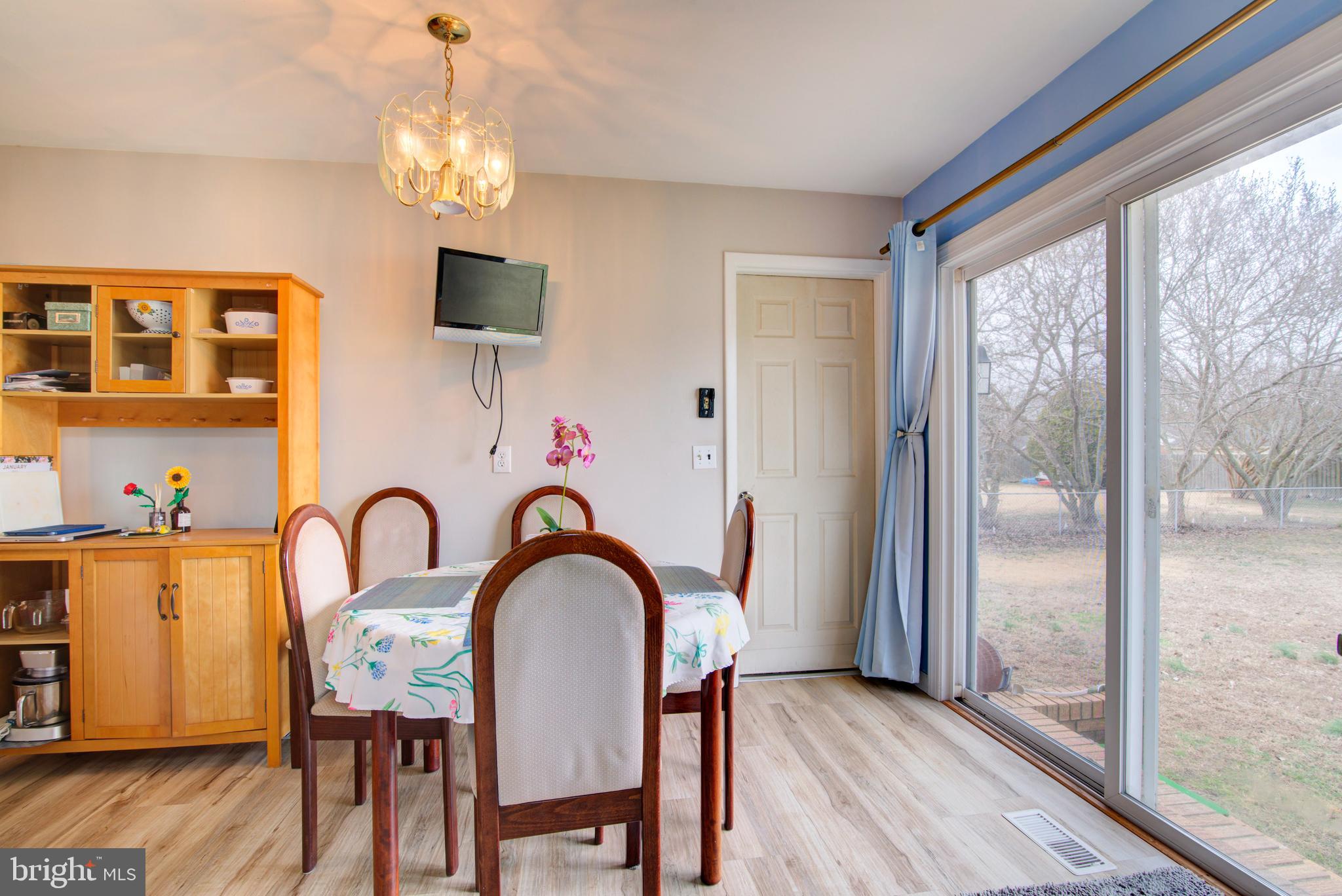 62 Darl Circle Colonial Beach, VA 22443 - Photo 15 of 47 a dining room with furniture a chandelier and wooden floor