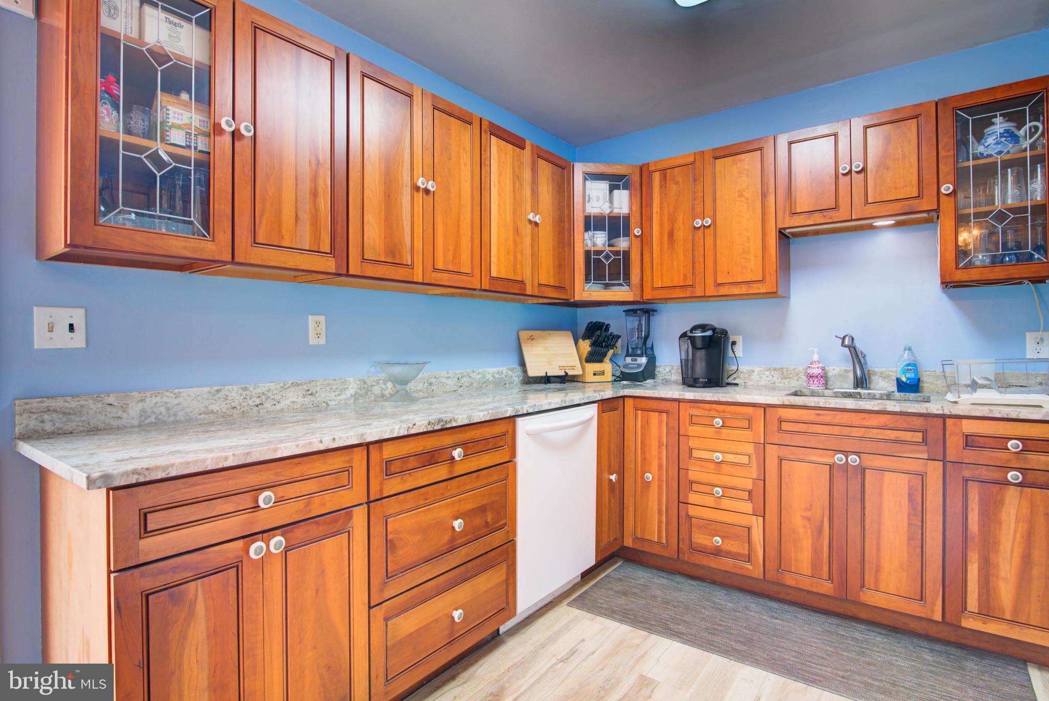62 Darl Circle Colonial Beach, VA 22443 - Photo 21 of 47 a kitchen with stainless steel appliances granite countertop wooden cabinets a sink and dishwasher with wooden floor