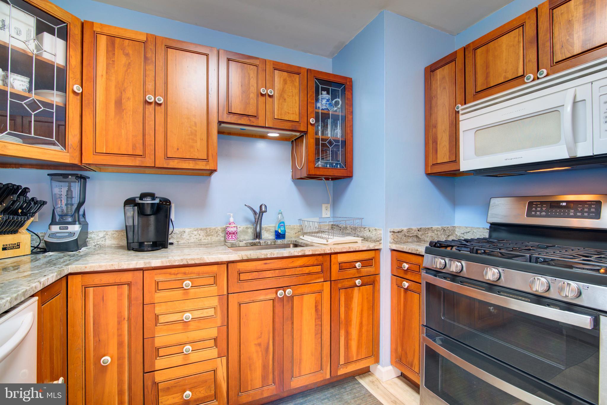 62 Darl Circle Colonial Beach, VA 22443 - Photo 22 of 47 a kitchen with stainless steel appliances granite countertop a sink stove and cabinets