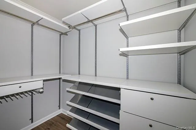 a view of cabinets and utility room with wooden floor