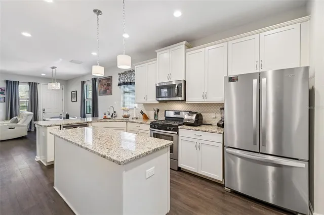 a bedroom with a bed and a lamp on dresser
