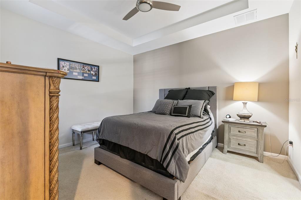 5714 Colony Glen Road Lithia, FL 33547 - Photo 12 of 66 a bedroom with a bed and a lamp on dresser