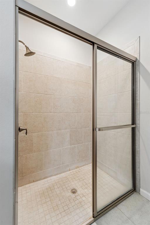 5714 Colony Glen Road Lithia, FL 33547 - Photo 15 of 66 a bathroom with a glass shower door