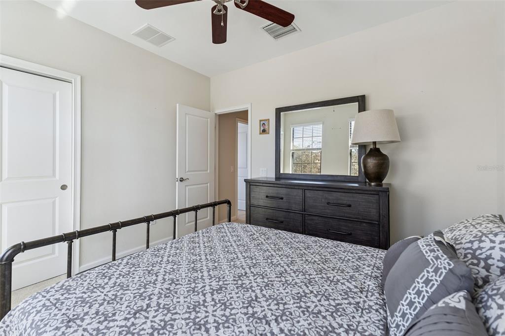 5714 Colony Glen Road Lithia, FL 33547 - Photo 19 of 66 a bedroom with a bed and a dresser