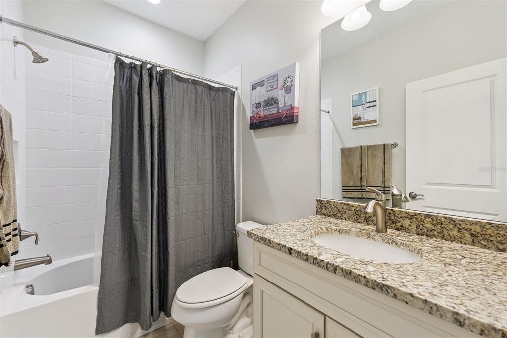 5714 Colony Glen Road Lithia, FL 33547 - Photo 22 of 66 a bathroom with a granite countertop sink toilet and shower