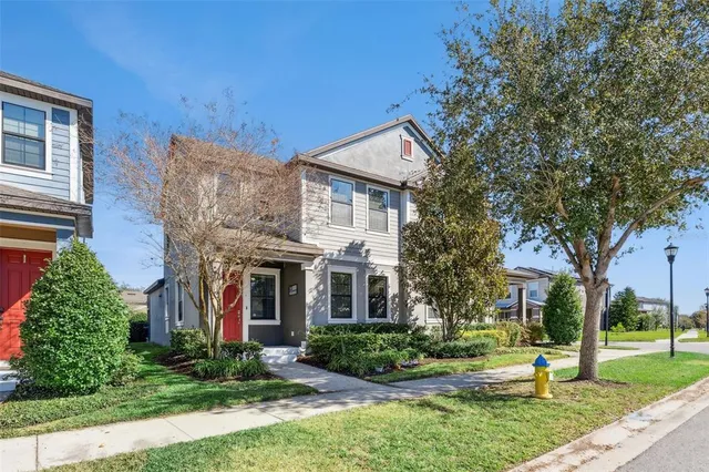 a view of a house with a yard and plants