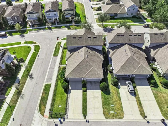 an aerial view of residential houses with outdoor space