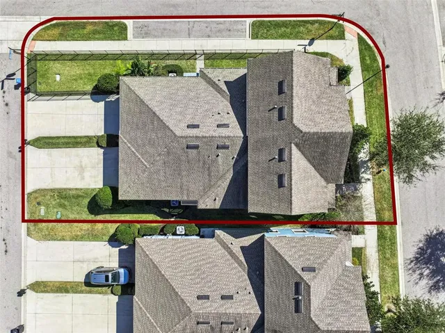 an aerial view of residential houses with city view