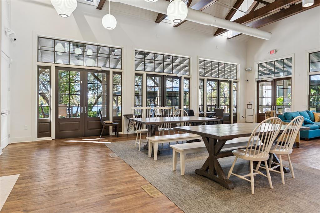 5714 Colony Glen Road Lithia, FL 33547 - Photo 45 of 66 a dining hall with couches a dining table and chairs with wooden floor