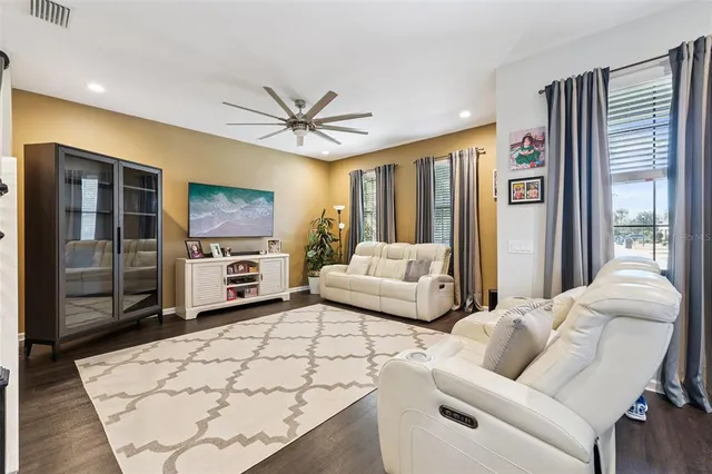 a living room with furniture and large windows
