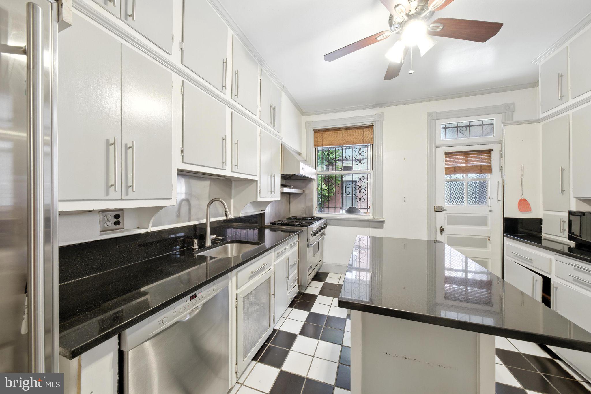 1763 U Street Northwest Washington, DC 20009 - Photo 7 of 29 a kitchen with stainless steel appliances granite countertop a sink and cabinets