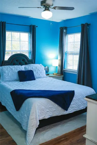 a bedroom with a large bed and a window