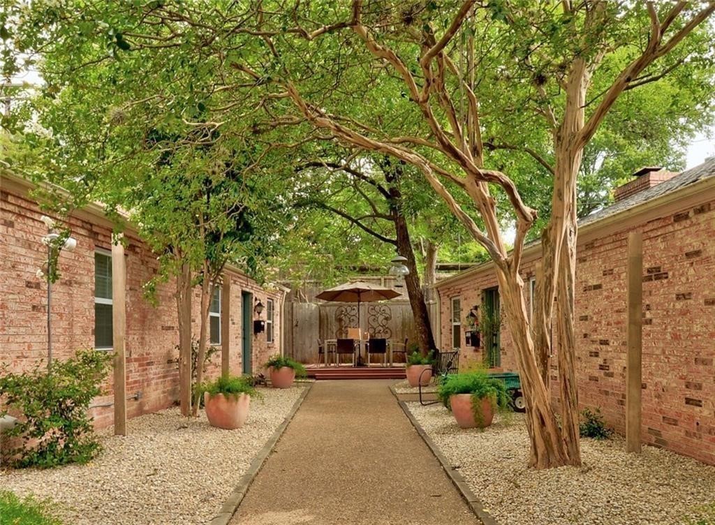 a view of a patio with table and chairs under an umbrella