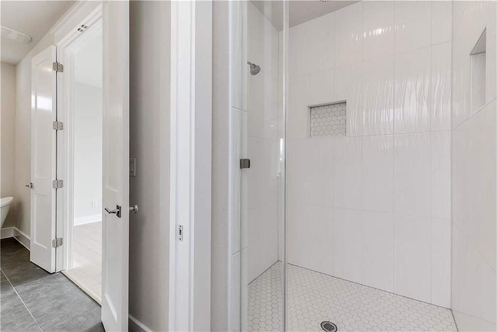 5002 Pecan Springs Road, Unit 10 Austin, TX 78723 - Photo 14 of 29 Bathroom featuring tiled shower and toilet