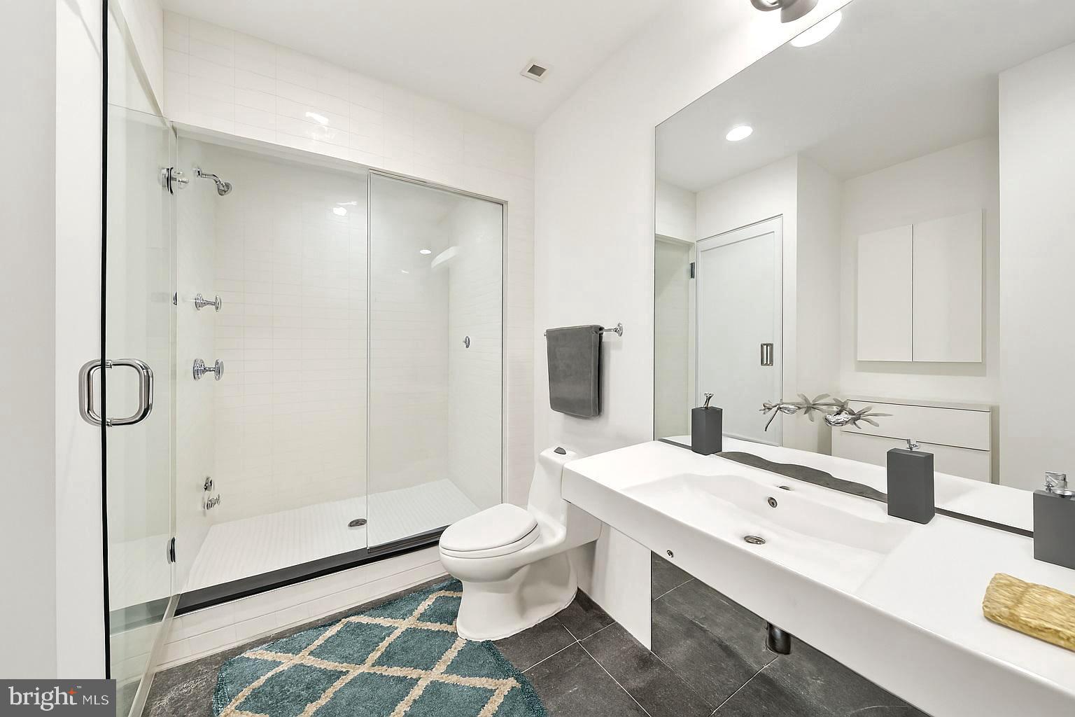 1600 Arch Street, Unit 1809 Philadelphia, PA 19103 - Photo 12 of 36 a bathroom with a double vanity sink toilet and shower